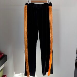 black velvet pants with orange pleated detailing on the side
